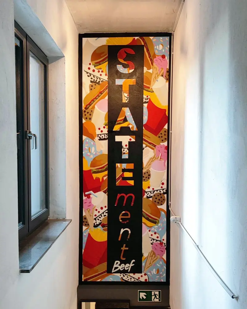Logo painting with fast food motifs in the background for Statement Beef in Giessen, Germany